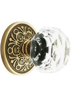 an ornate door handle with glass knobs