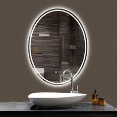 a white sink sitting under a bathroom mirror next to a wall mounted faucet