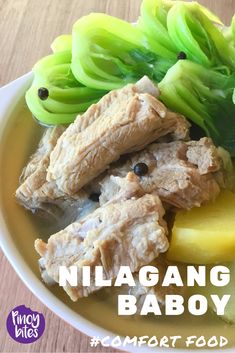 a bowl filled with meat and vegetables on top of a wooden table next to the words nilagang baboy