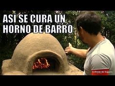 a man standing in front of an outdoor pizza oven with the words asi se cura un horno debarro