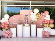 there is a display with balloons and decorations on the table in front of a window