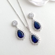 Sapphire Blue Stone Earrings, Bracelet, Necklace Set Made of Cubic Zirconia for Weddings If you are looking for matching earrings, necklace bracelet set in blue color, this sapphire blue store jewelry set with matching earrings, necklace, and adjustable bracelet is a beautiful set. The sapphire blue stone jewelry set is great for the bride, bridesmaids, and every woman looking for sapphire blue color jewelry. They are made of high-quality cubic zirconia and are available in silver, gold, and ros Sapphire Jewelry With Sparkling Stones For Wedding, Sapphire Dangle Jewelry For Wedding, Elegant Sapphire Jewelry With Hand Set, Elegant Sapphire Jewelry For Party, Teardrop Sapphire Cubic Zirconia Jewelry, Sapphire Cubic Zirconia Jewelry For Wedding, Teardrop Sapphire-colored Cubic Zirconia Jewelry, Sapphire Cubic Zirconia Wedding Jewelry, Elegant Sapphire Jewelry Sets For Party