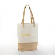 a white and tan tote bag with the words berkley haas on it