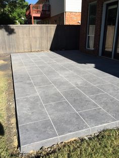 a concrete patio being built in front of a house