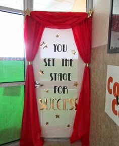 a door decorated with red drapes and gold lettering that says, you set the stage for success