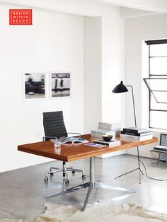 an office with a desk, chair and pictures on the wall