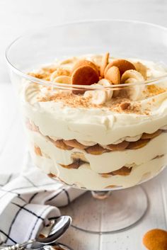 an image of a dessert in a glass dish with nuts on top and cinnamons around the edges