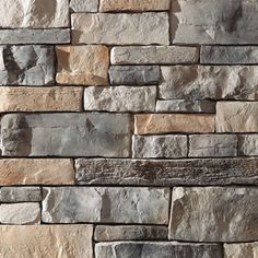 a stone wall that is made out of various types of stones