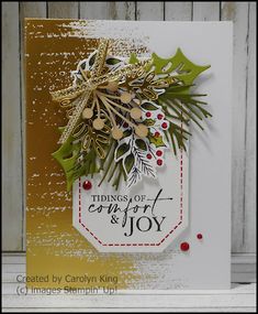 a christmas card with pine cones and holly on the front, which reads things of joy & joy