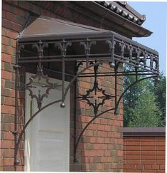 an iron gate on the side of a brick building