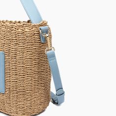 Embrace the sweetness of the season with this adorable mini tote bucket bag composed of woven straw. Featuring luxurious vegan leather detailing to bring both style and durability to your beach or picnic outfits. 100% Vegan Leather, 100% Straw 12''W x 9.5''H x 6''D 23'' adjustable/ removable Strap 7" Top Handle Magnetic Snap Closure 1 inner zipper pocket, 2 inner slit pockets 19.93 oz Style# U2CG01 Bucket Tote Bag, Bucket Tote, Leather Detailing, Basket Tote, Straw Basket, Bow Bag, Vegan Leather Handbag, Designer Crossbody Bags, Basket Bag