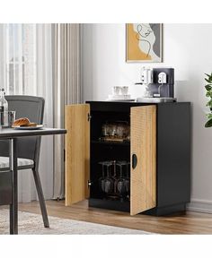 an open cabinet with drinks in it next to a dining room table