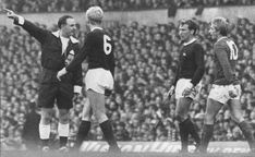 an old black and white photo of two soccer players giving instructions to their team mates