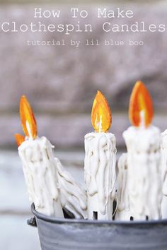 some candles are sitting in a pot with the words how to make clothespin candles