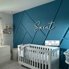 a baby's room with a blue wall and white crib in the corner