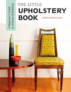 the little upholstery book is on display in front of a chair and table