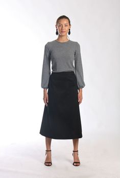 "Be right on clean minimal look with Aline midi skirt in timeless simplicity Black cotton skirt sits a little high on waist making your silhouette long and lean Midi length is super chic for this season Pair with simple top and heels or knee high boots to keep style minimal and polished Or wear as a chic casual skirt paired with snickers or athletic shoes -Tailored fit -Waist sits around naval -Side hidden zipper -Made of soft feel medium weighted cotton fabric with hint of stretch -Finishing is Solid Wrap Skirt For Work, Solid Color Wrap Skirt For Work, Relaxed Lined Maxi Skirt, Classic Relaxed Fit Lined Maxi Skirt, Fitted Wrap Skirt For Workwear, Relaxed Fit Midi Wrap Skirt For Work, Fitted Long Wrap Skirt In Solid Color, Long Lined Wrap Skirt For Fall, Solid Color Fitted Long Wrap Skirt