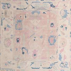 an antique rug with blue and pink colors