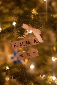 a wooden ornament hanging from the side of a christmas tree