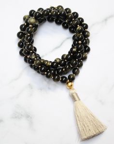 'I am empowered to pursue my passions.' Gold Sheen Obsidian, also known as the "wizard stone," has a long history of being used as a scrying mirror for divination and future prediction. Its reflective surface helps to bring clarity to the mind and alleviate confusion, allowing for deep introspection and personal growth. The reflective nature of Gold Sheen Obsidian has made it a popular tool for self-reflective meditation and fostering internal growth and understanding. Its properties also promot Spiritual Obsidian Jewelry With Natural Stones, Handmade Obsidian Necklaces For Meditation, Spiritual Obsidian Necklace With Gemstone, Spiritual Obsidian Gemstone Necklace, Spiritual Onyx Beads Jewelry 8mm, Obsidian Gemstone Beads Necklace For Meditation, Bohemian Obsidian Jewelry With Natural Stones, Spiritual Onyx Jewelry With Gemstone Beads, Spiritual Obsidian Jewelry For Meditation