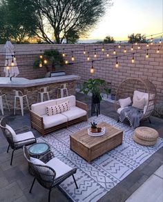 an outdoor patio with wicker furniture and string lights