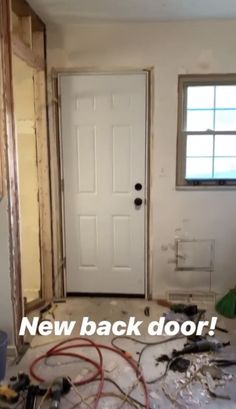 a room that is being remodeled with new doors and tools on the floor in front of it