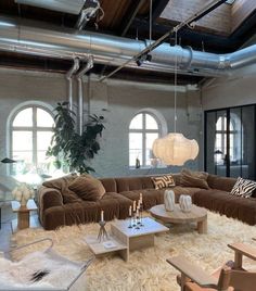 a living room filled with furniture and lots of windows