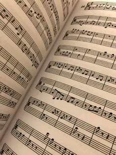 an open book with sheet music on it