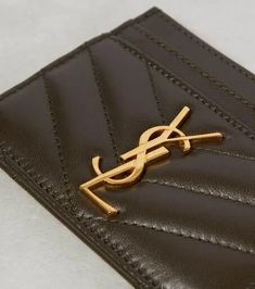 Made from matelassé leather, the Cassandre card holder is completed with signature monogram in gold. One of the most famous symbols in fashion, the YSL monogram consists of the intertwined initials of Saint Laurent's founder..Internal details: leather lining.Material: leather.Comes with dust bag.Comes with a box.Made in Italy.Height 7,5cm-3'.Width 10,5cm-4' Saint Laurent Bags, Leather Card Holder, Saint Laurent Bag, Card Holder Leather, Personal Shopping, Women's Bags, In Fashion, Bags Women, Saint Laurent