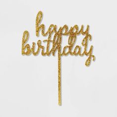 a cake topper that says happy birthday with gold glitters on it and the words'happy birthday'written in cursive