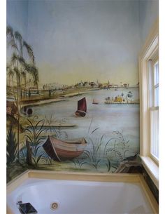 a bath tub sitting next to a painting on the side of a wall in a bathroom