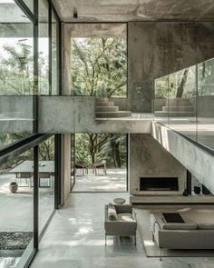 the interior of a modern house with glass walls