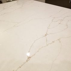 a white marble counter top in a bathroom