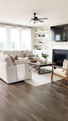 a living room filled with furniture and a flat screen tv mounted on the wall above a fireplace