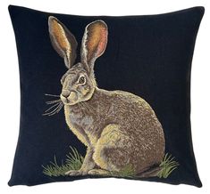 a black pillow with a drawing of a rabbit on it's front and back