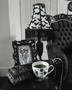 a black and white photo of a living room with halloween decorations on the couches