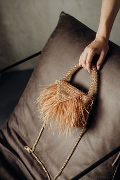 Elegant Beaded Handbag with Feather Fringe Our bag's exquisite crystal beads create a mesmerizing shimmer that catches the light from every angle, adding a touch of glamour to your ensemble. A sturdy, beaded handle ensures easy carrying. Includes a detachable gold chain strap for versatile wear as a shoulder bag or crossbody. The top of the bag features a sturdy and convenient snap closure, ensuring that your belongings remain safe and protected. Each bag is meticulously crafted by skilled artis Feather Fringe, Fringe Handbags, Crystal Bags, Beaded Evening Bags, Statement Bag, Beaded Handbag, Ostrich Feather, Evening Purse, Ostrich Feathers