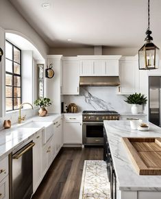 a kitchen with marble counter tops and white cabinets, along with an island in the middle