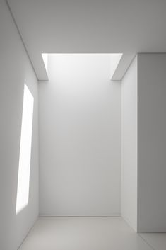 an empty room with white walls and two windows