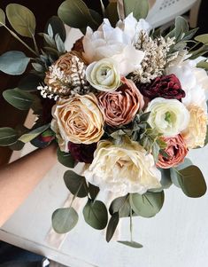 a bridal bouquet with white and red flowers