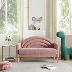 a living room with pink couches and a green dinosaur statue in the corner next to it