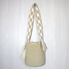 100% handwoven bag by Colombian women belonging to the Wayuu community. The elaboration of this product takes between 20 to 23 days, their sale is one of the main sources of support for their community. It is a completely comfortable, versatile, resistant bag; Its colors are striking and combine with any garment. Recommendations  It is suggested that when washing this type of backpack, the cords are inserted inside it and that it be placed inside a washing bag. It is not recommended to put it in the dryer, instead it can be hung to dry completely. specs Height: 10 In   /  27 cm Width:  09 In  /  25 cm Strap:   42 In  /  109 cm Made in:  La Guajira - Colombia Handmade Natural Backpack For Everyday Use, Handwoven Cream Rectangular Bucket Bag, Cream Handwoven Rectangular Bucket Bag, Cream Rectangular Handwoven Bucket Bag, Handwoven Cream Bag For Daily Use, Cream Handwoven Bag For Daily Use, Handwoven Cream Bags For Daily Use, Eco-friendly Handwoven Cream Bag, Beige Handwoven Bucket Shoulder Bag