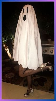 a woman dressed in a ghost costume posing for the camera with her legs crossed and shoes on