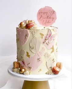 a birthday cake decorated with pink and gold decorations