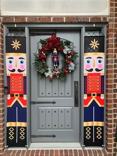 a wreath on the front door of a building with nutcrackers painted on it