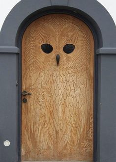 an owl carved into the side of a door