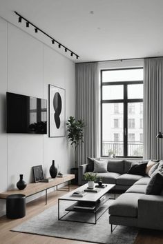 a living room filled with furniture and a large window next to a wall mounted flat screen tv