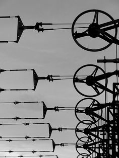 several street lights and wires against a cloudy sky