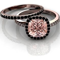 two engagement rings with pink and black diamonds