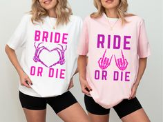 two women standing next to each other wearing t - shirts that say bride or die